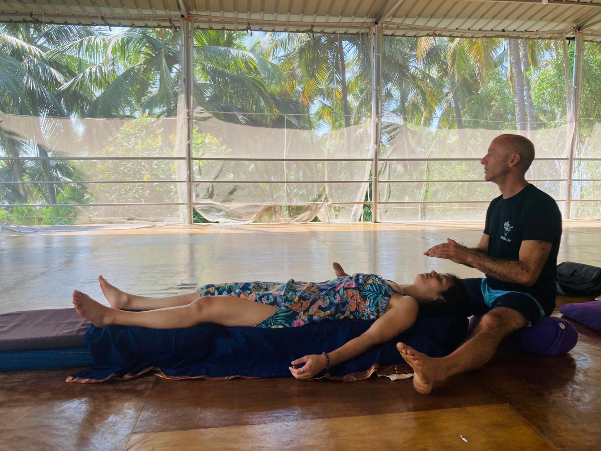 A quiet treatment moment in an open-air tropical setting